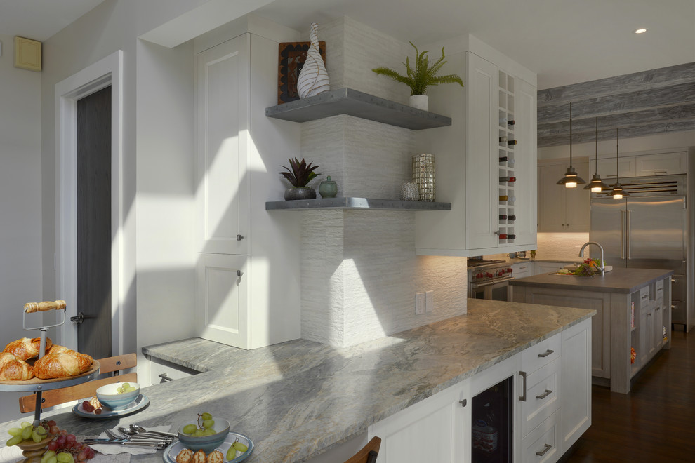 Large mountain style u-shaped medium tone wood floor and brown floor eat-in kitchen photo in New York with a farmhouse sink, shaker cabinets, white cabinets, solid surface countertops, white backsplash, porcelain backsplash, stainless steel appliances and an island