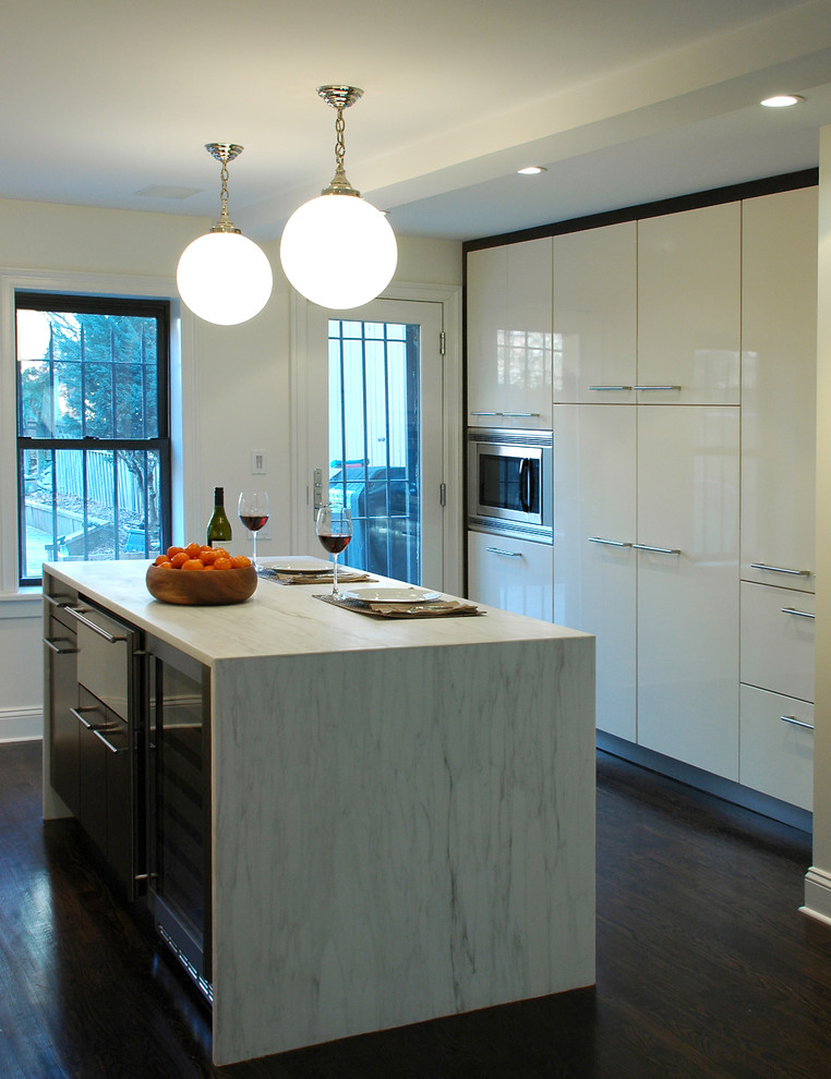 Modern kitchen in New York with flat-panel cabinets and white cabinets.