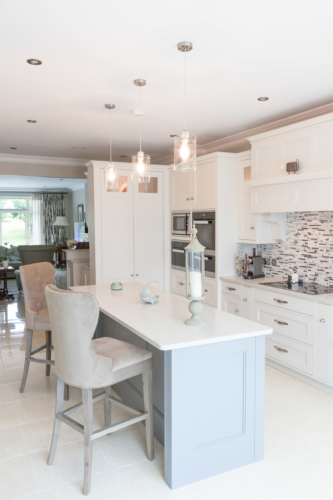 Inspiration for a medium sized beach style kitchen/diner in Other with recessed-panel cabinets, white cabinets, quartz worktops, multi-coloured splashback, ceramic splashback, white floors, white worktops, black appliances and an island.