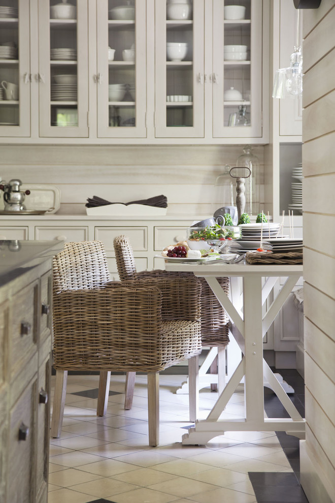 Cette photo montre une cuisine tendance avec un placard à porte affleurante, des portes de placard blanches, une crédence beige, un sol en carrelage de céramique et un sol blanc.