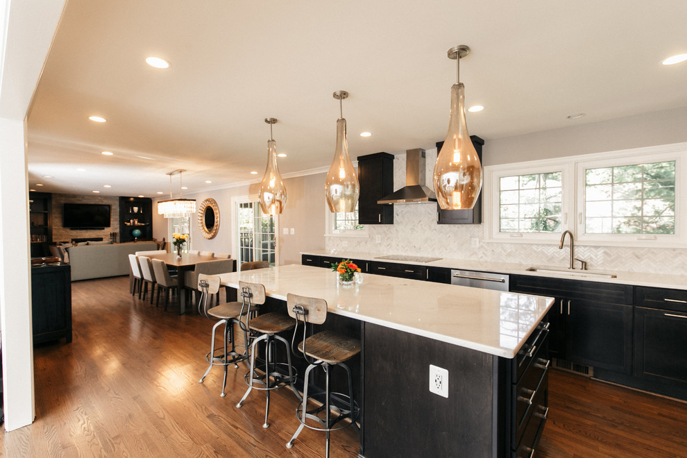 Eat-in kitchen - mid-sized shabby-chic style l-shaped dark wood floor eat-in kitchen idea in DC Metro with an undermount sink, shaker cabinets, white cabinets, quartzite countertops, gray backsplash, stone tile backsplash, stainless steel appliances and an island