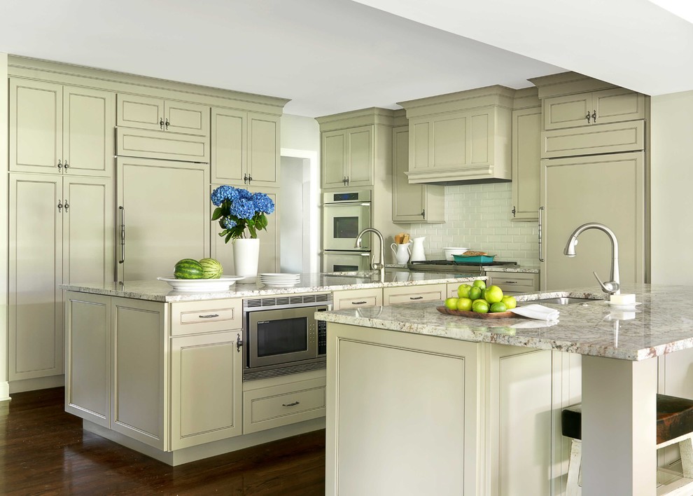 Inspiration for a timeless kitchen remodel in St Louis with subway tile backsplash, granite countertops and paneled appliances
