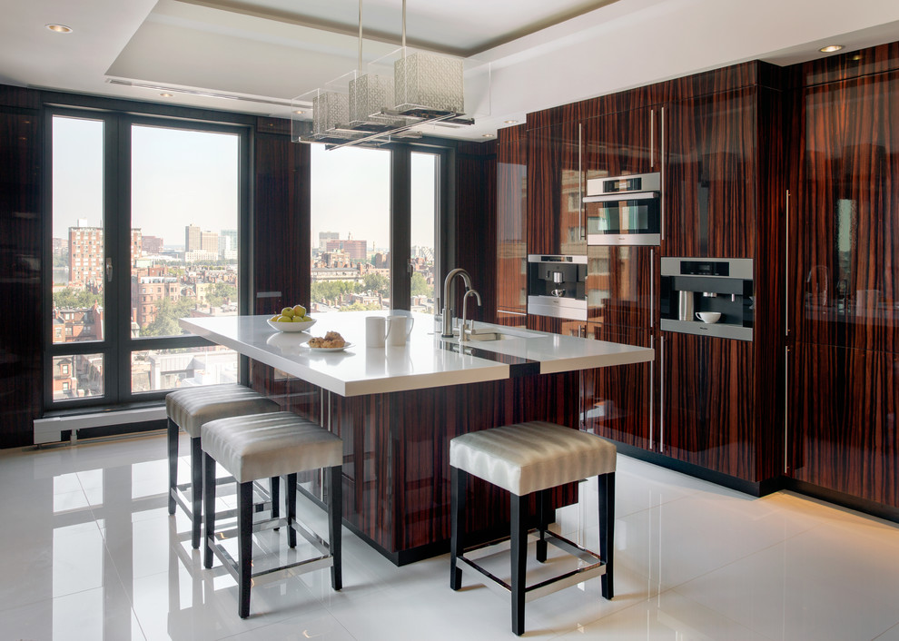 Photo of a contemporary single-wall kitchen/diner in Boston with flat-panel cabinets, dark wood cabinets, engineered stone countertops and an island.