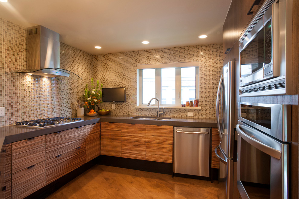 Eat-in kitchen - contemporary u-shaped light wood floor eat-in kitchen idea in Denver with a double-bowl sink, flat-panel cabinets, medium tone wood cabinets, multicolored backsplash, mosaic tile backsplash, stainless steel appliances and solid surface countertops