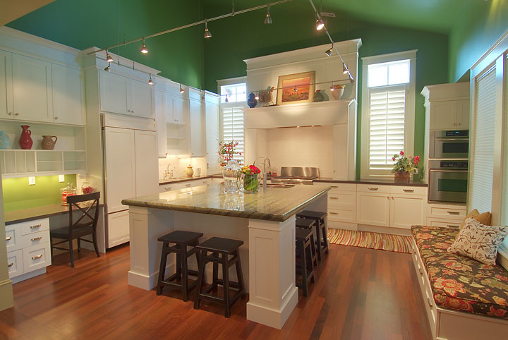 Eat-in kitchen - large farmhouse l-shaped medium tone wood floor eat-in kitchen idea in Salt Lake City with an undermount sink, recessed-panel cabinets, white cabinets, granite countertops, white backsplash, subway tile backsplash, stainless steel appliances and an island