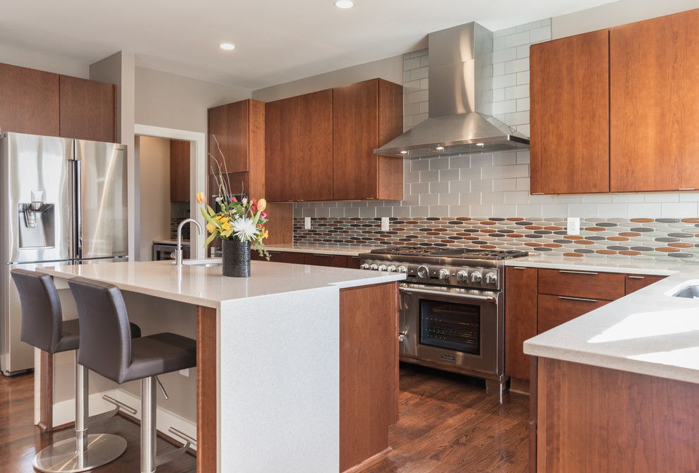 Inspiration for a large mid-century modern u-shaped medium tone wood floor open concept kitchen remodel in DC Metro with an undermount sink, flat-panel cabinets, medium tone wood cabinets, quartzite countertops, white backsplash, subway tile backsplash, stainless steel appliances and an island