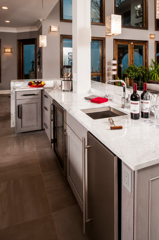 Inspiration for a large contemporary l-shaped ceramic tile open concept kitchen remodel in Detroit with an undermount sink, recessed-panel cabinets, white cabinets, quartz countertops, white backsplash, subway tile backsplash, stainless steel appliances and two islands