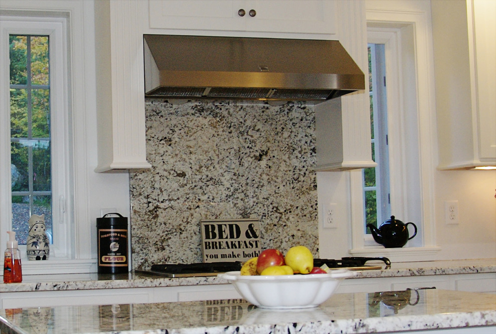 A full length granite backsplash over the stove Traditional Kitchen