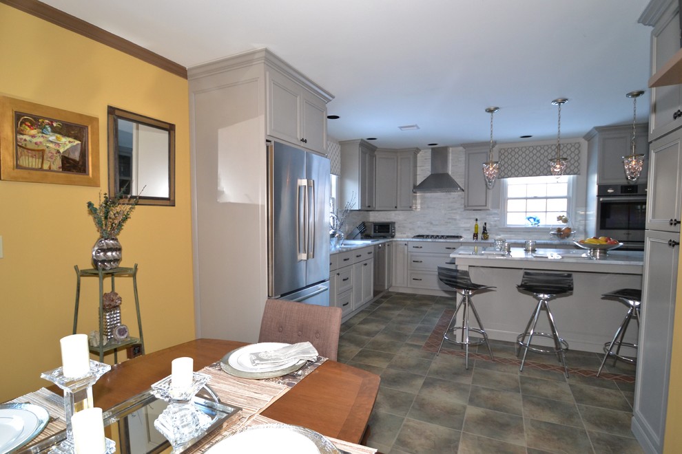 Example of a small trendy l-shaped terra-cotta tile eat-in kitchen design in Philadelphia with an undermount sink, flat-panel cabinets, gray cabinets, quartzite countertops, gray backsplash, mosaic tile backsplash, stainless steel appliances and an island