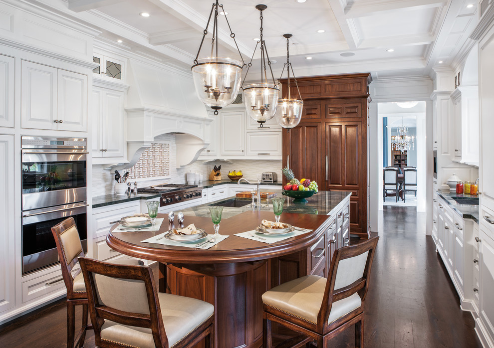 Inspiration for a timeless dark wood floor kitchen remodel in Boston with raised-panel cabinets, white cabinets, multicolored backsplash, paneled appliances and an island