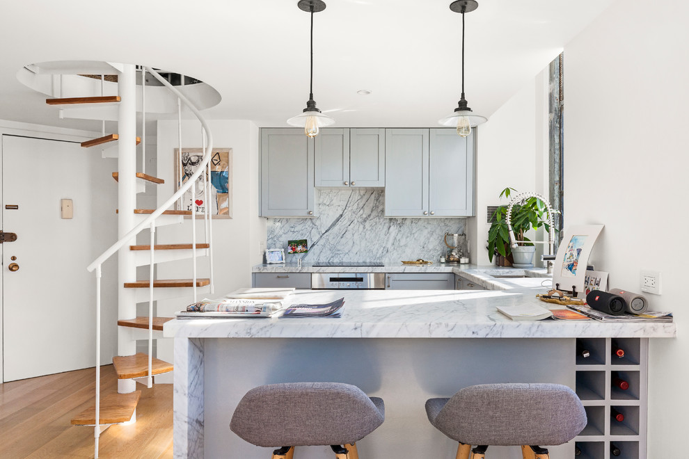 Inspiration for a contemporary u-shaped light wood floor kitchen remodel in New York with an undermount sink, shaker cabinets, gray cabinets, marble countertops, gray backsplash, marble backsplash, stainless steel appliances, a peninsula and gray countertops