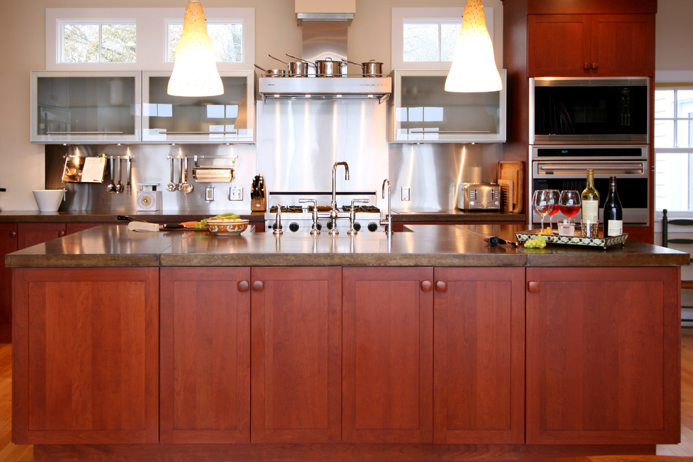 Exempel på ett kök, med en rustik diskho, skåp i shakerstil, skåp i mellenmörkt trä, bänkskiva i betong, stänkskydd med metallisk yta, rostfria vitvaror och mellanmörkt trägolv