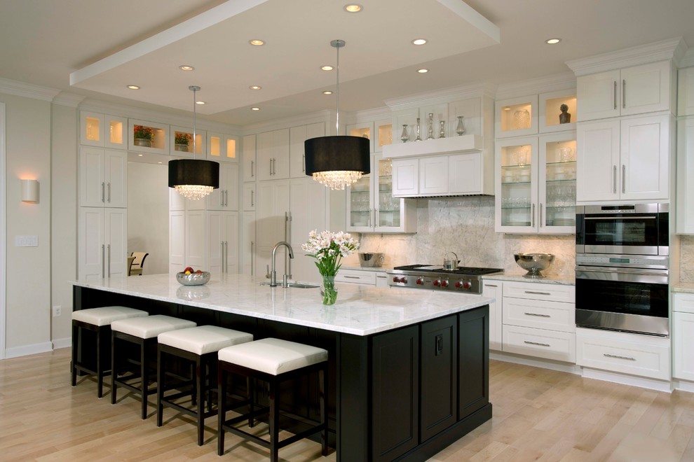 Example of a large trendy galley light wood floor open concept kitchen design in DC Metro with an undermount sink, shaker cabinets, white cabinets, marble countertops, multicolored backsplash, stone slab backsplash, stainless steel appliances and an island