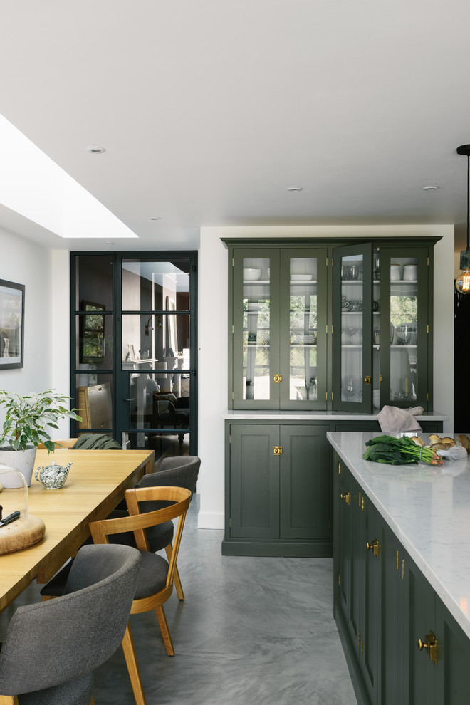 Photo of a medium sized contemporary kitchen/diner in Other with shaker cabinets, green cabinets, quartz worktops, white splashback, integrated appliances, an island and white worktops.