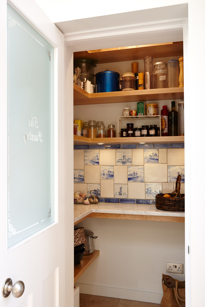 Example of a trendy kitchen pantry design in London