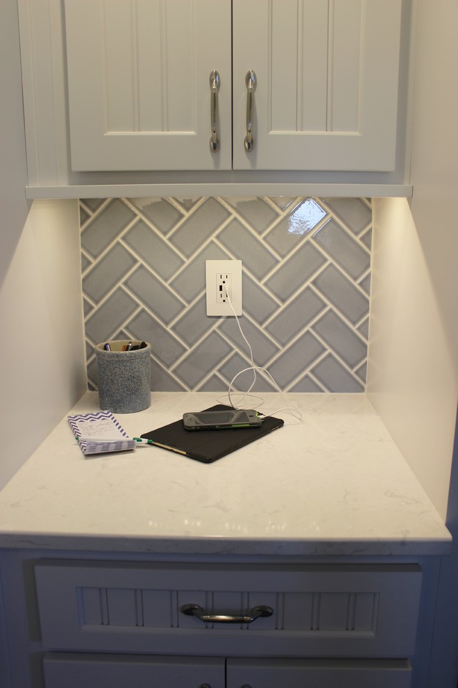 Inspiration for a mid-sized country u-shaped porcelain tile and blue floor enclosed kitchen remodel in Other with an undermount sink, white cabinets, quartz countertops, blue backsplash, subway tile backsplash, stainless steel appliances, no island and white countertops