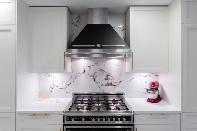 Bertazzoni appliances in a White and gold kitchen with Marble