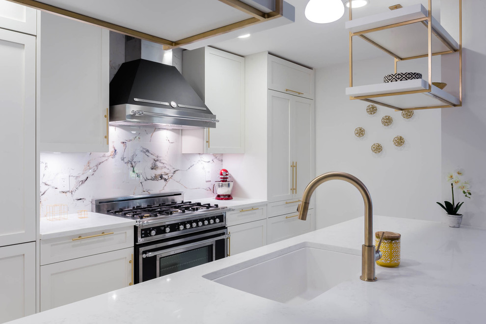 A kitchen with white shaker and Gold / Brass