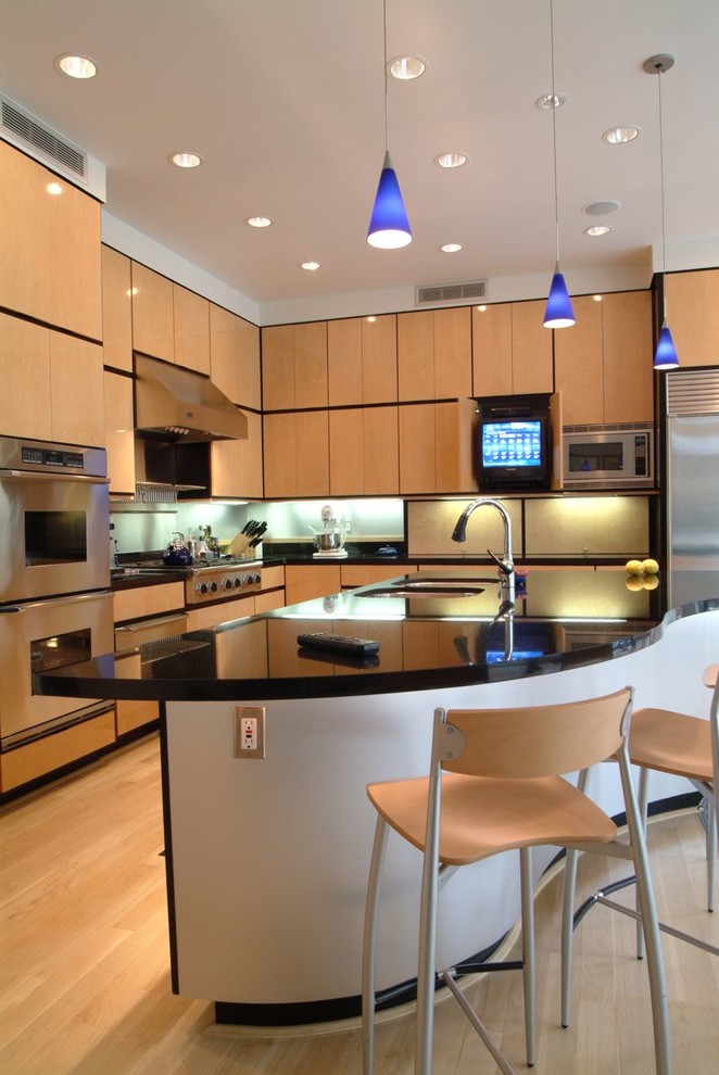 Inspiration for a contemporary light wood floor kitchen remodel in Jackson with an undermount sink, flat-panel cabinets and stainless steel appliances