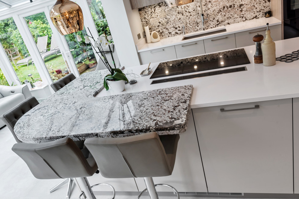 This is an example of a contemporary kitchen in Berkshire with granite worktops and an island.