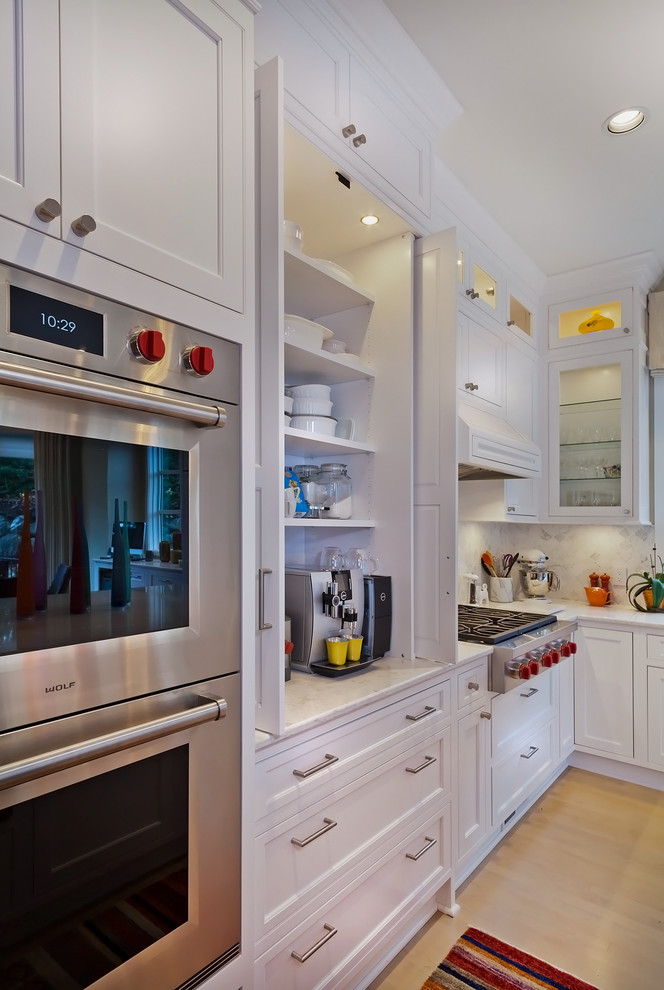 Large transitional l-shaped light wood floor eat-in kitchen photo in Minneapolis with a triple-bowl sink, beaded inset cabinets, white cabinets, quartz countertops, white backsplash, mosaic tile backsplash, paneled appliances and an island