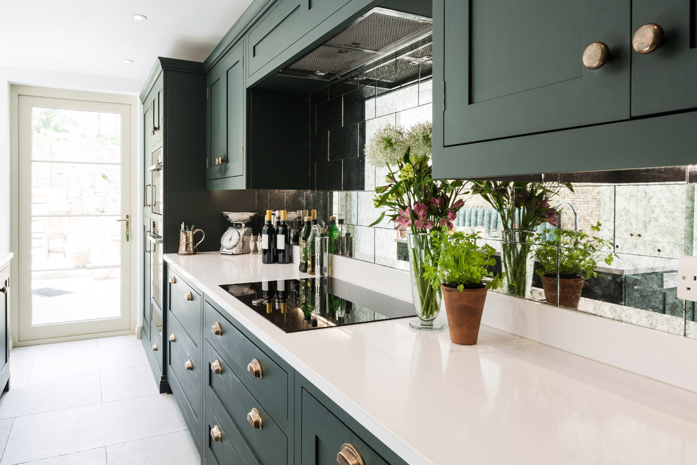 Photo of a large classic l-shaped kitchen/diner in London with an integrated sink, shaker cabinets, green cabinets, quartz worktops, metallic splashback, glass tiled splashback, integrated appliances, limestone flooring, an island, white floors and white worktops.