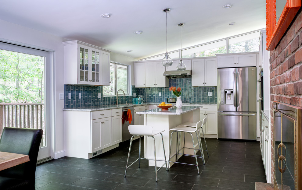Eat-in kitchen - mid-sized transitional l-shaped slate floor and brown floor eat-in kitchen idea in Boston with an undermount sink, shaker cabinets, white cabinets, blue backsplash, glass tile backsplash, stainless steel appliances and an island