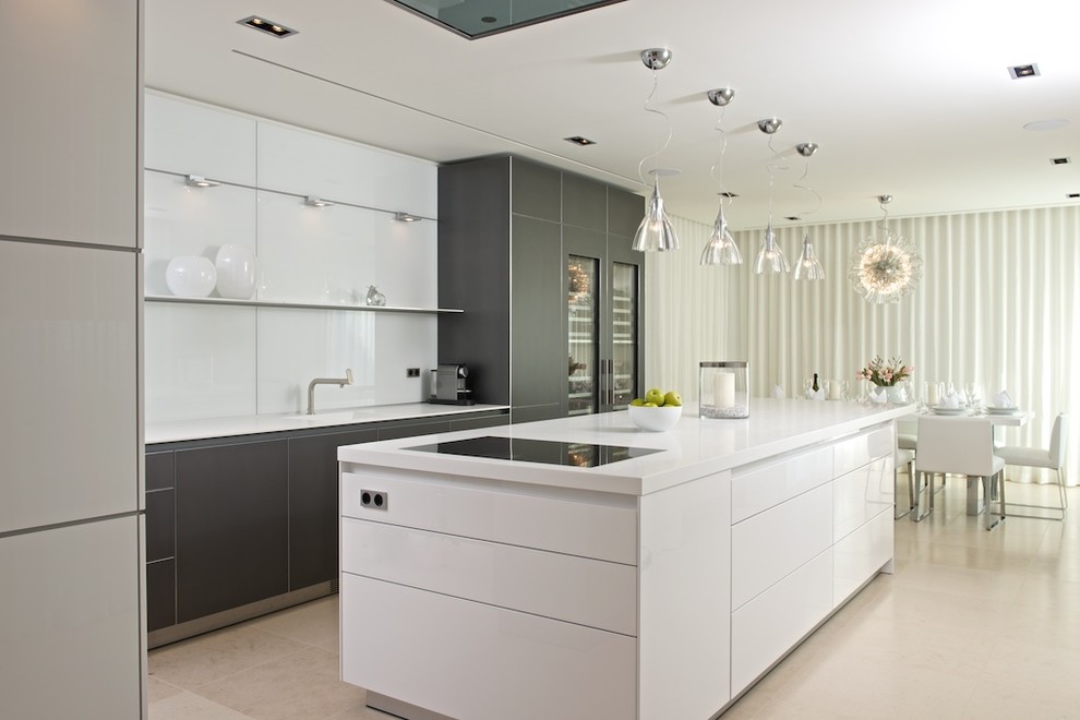 Inspiration for a large contemporary l-shaped kitchen/diner in Other with black cabinets, white splashback, an island, an integrated sink, glass-front cabinets, stainless steel appliances, marble flooring, composite countertops and white worktops.