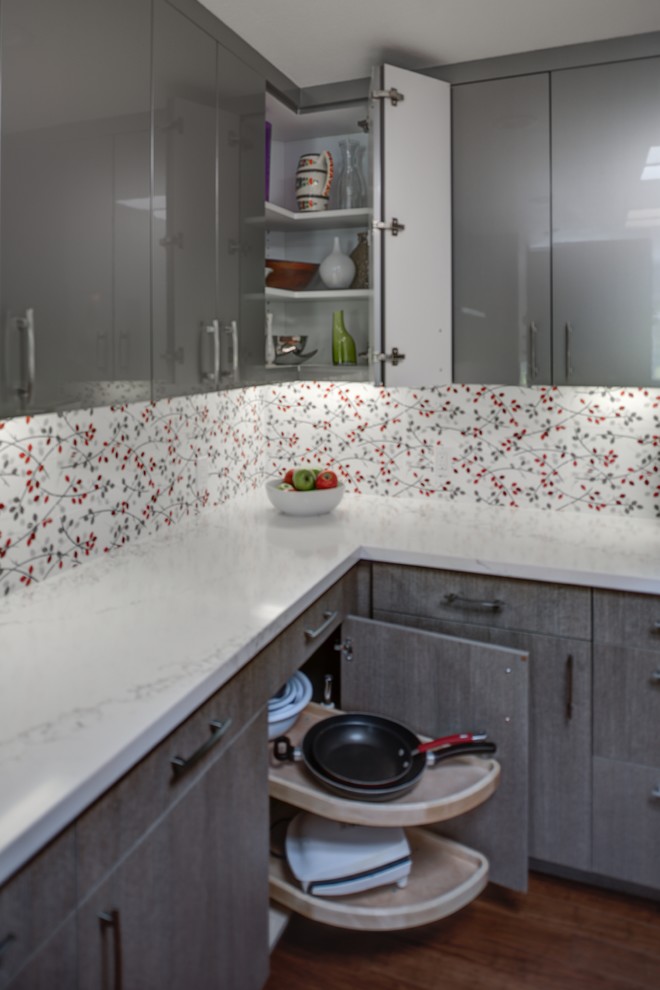Mid-sized trendy l-shaped medium tone wood floor eat-in kitchen photo in San Francisco with an undermount sink, flat-panel cabinets, gray cabinets, quartz countertops, red backsplash, porcelain backsplash, stainless steel appliances and an island