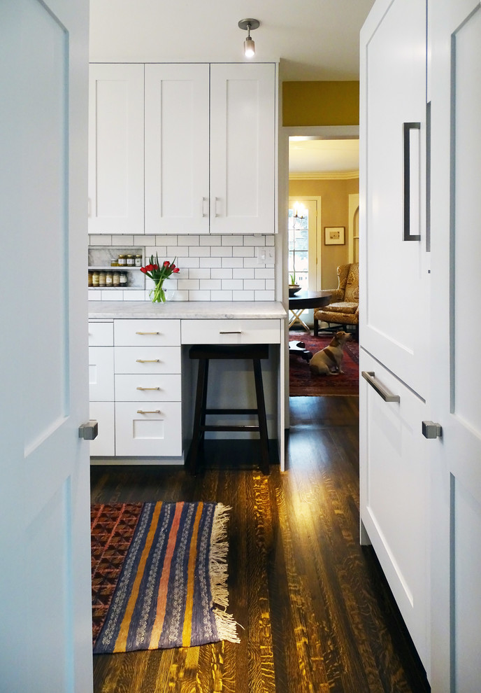 Moderne Küche mit Waschbecken, Marmor-Arbeitsplatte, Küchenrückwand in Weiß, Rückwand aus Metrofliesen, Küchengeräten aus Edelstahl und dunklem Holzboden in Minneapolis