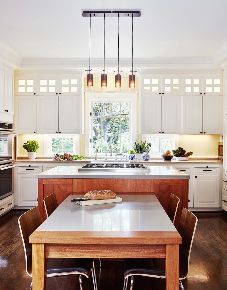 Example of a transitional dark wood floor eat-in kitchen design in San Francisco with raised-panel cabinets, white cabinets, yellow backsplash, stainless steel appliances and an island