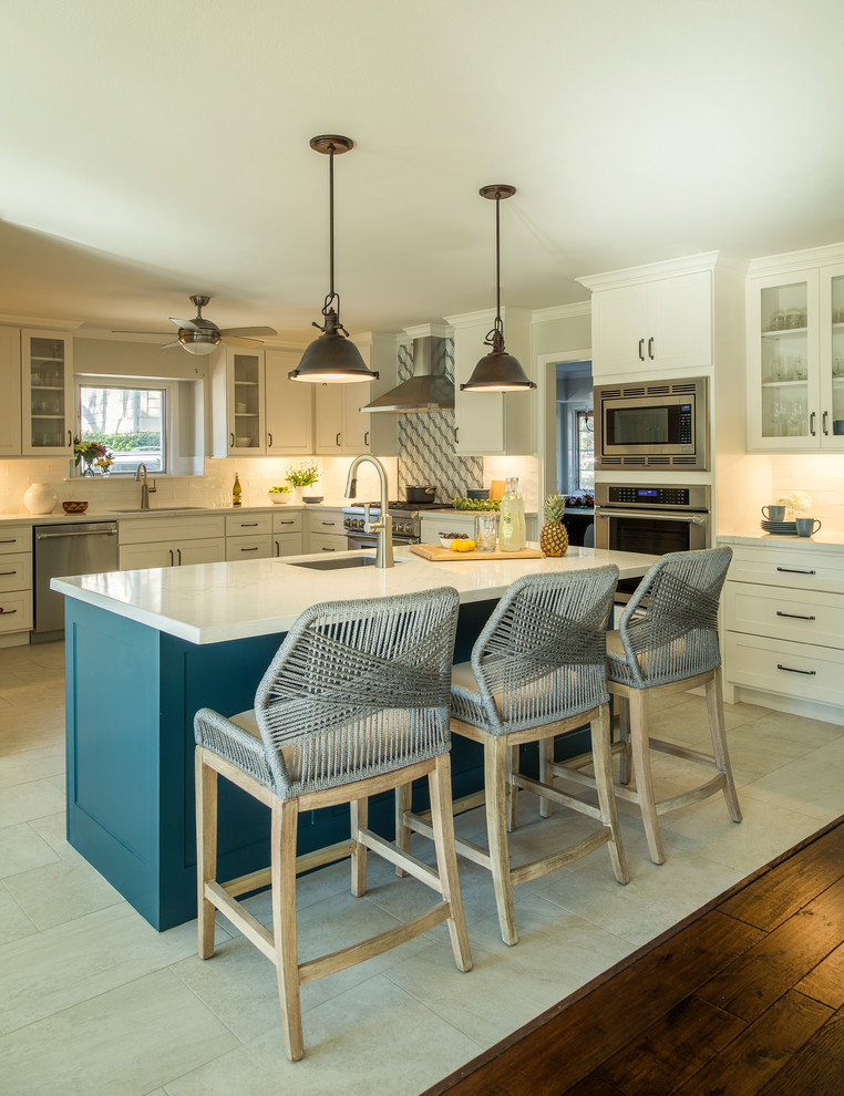 Example of a large transitional u-shaped beige floor and porcelain tile eat-in kitchen design in Other with an undermount sink, shaker cabinets, white cabinets, white backsplash, subway tile backsplash, stainless steel appliances, an island, white countertops and quartzite countertops