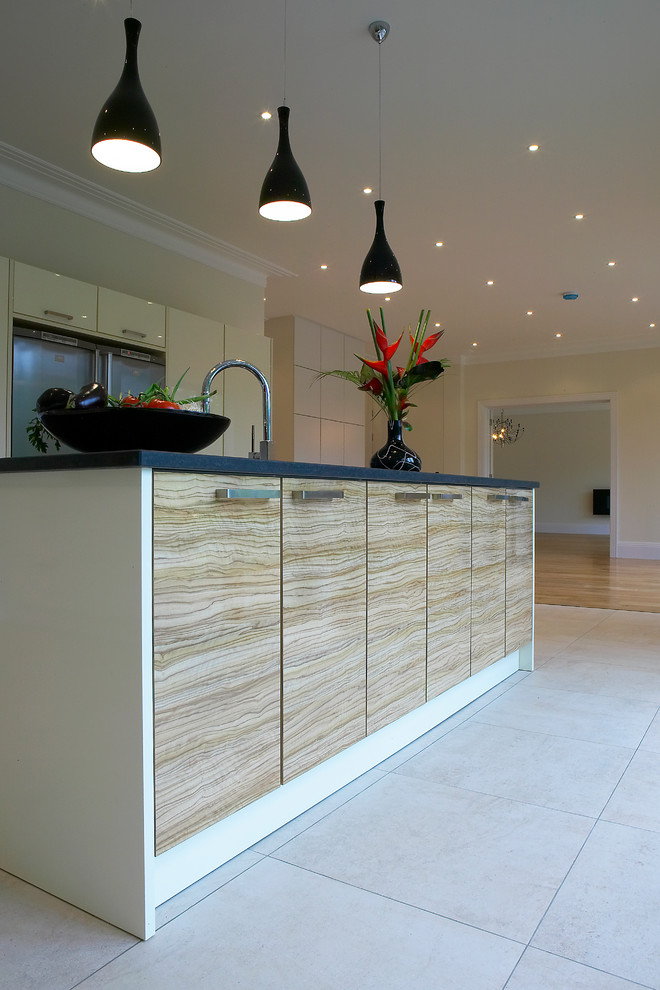 Design ideas for a large contemporary open plan kitchen in Berkshire with flat-panel cabinets, white cabinets, granite worktops, red splashback, glass sheet splashback, stainless steel appliances, porcelain flooring and an island.