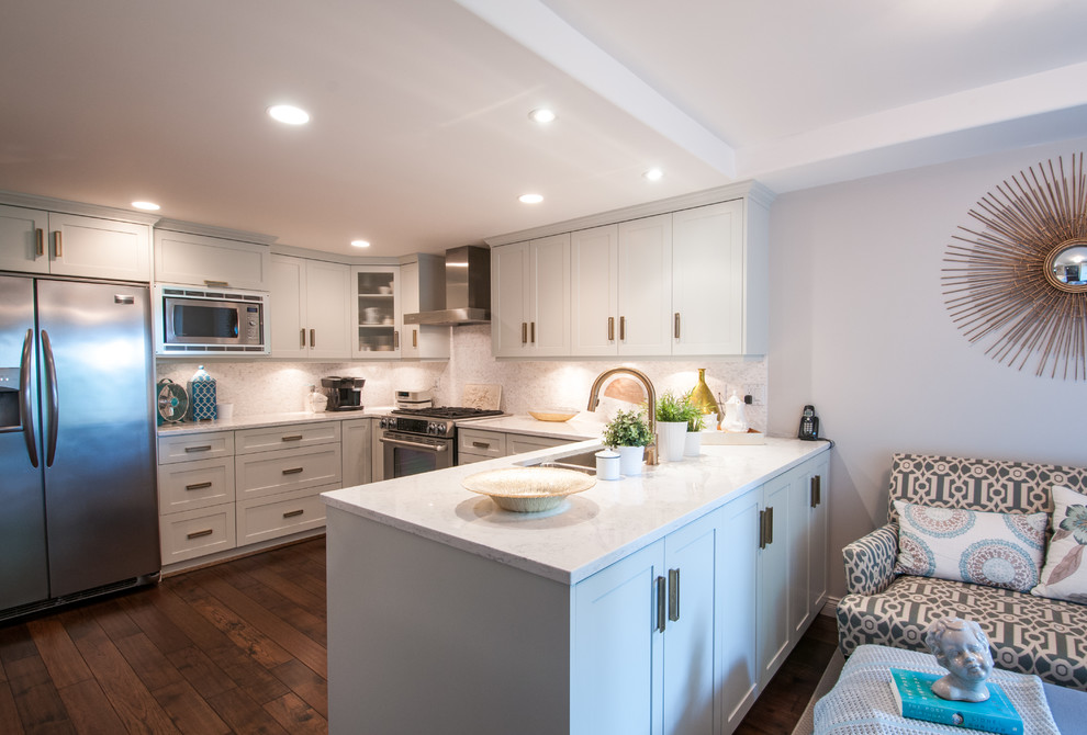This is an example of a medium sized classic u-shaped kitchen in Vancouver with raised-panel cabinets, stainless steel appliances, dark hardwood flooring, a breakfast bar, a double-bowl sink and multi-coloured splashback.