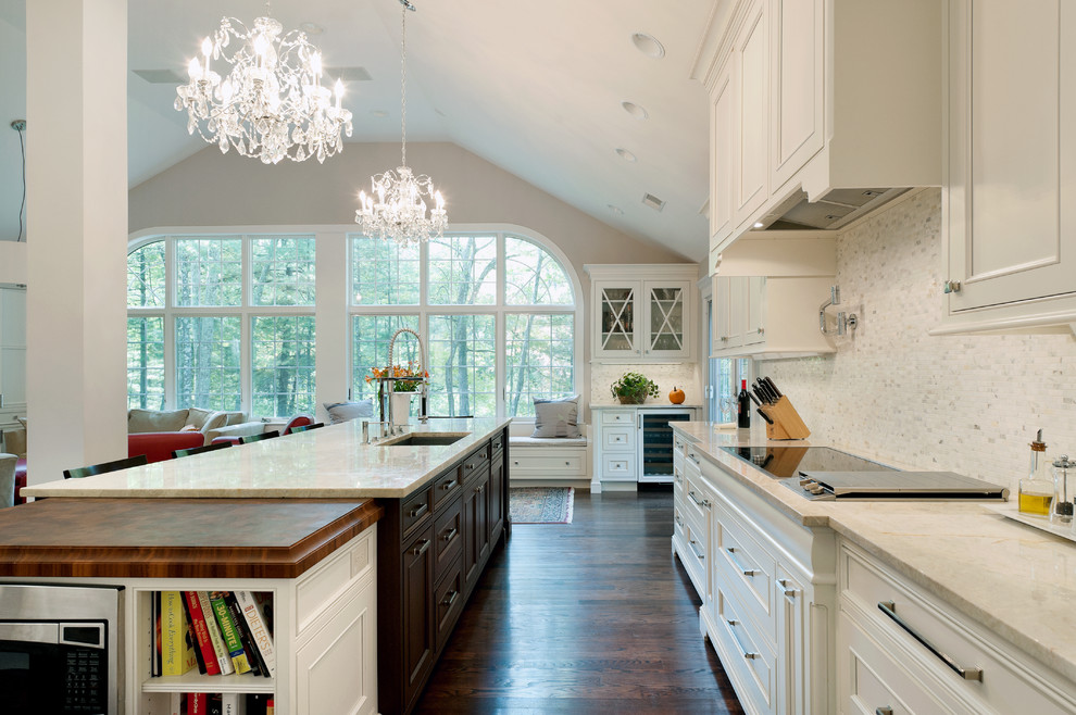 Inspiration for a timeless dark wood floor open concept kitchen remodel in Boston with an undermount sink, recessed-panel cabinets, white cabinets, quartzite countertops, white backsplash and marble backsplash