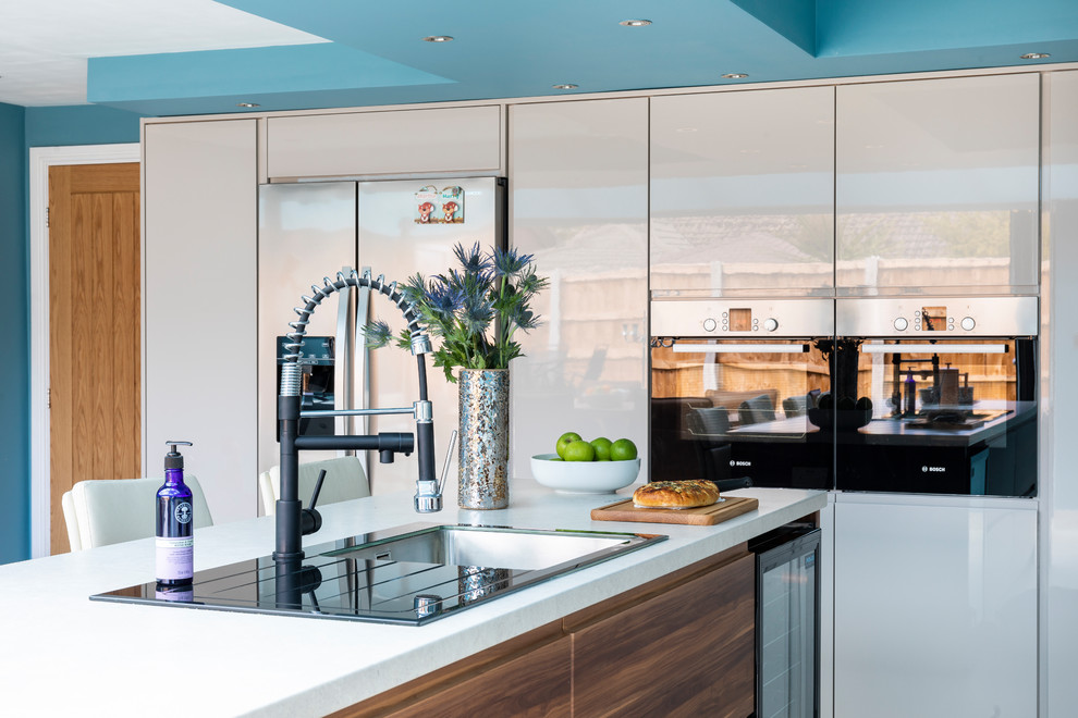 This is an example of a contemporary kitchen in Manchester with white floors.