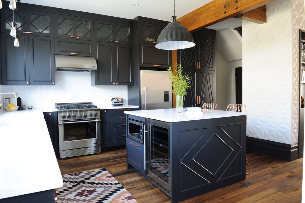 Mid-sized eclectic l-shaped medium tone wood floor open concept kitchen photo in Vancouver with a farmhouse sink, flat-panel cabinets, black cabinets, quartz countertops, white backsplash, ceramic backsplash, stainless steel appliances and an island