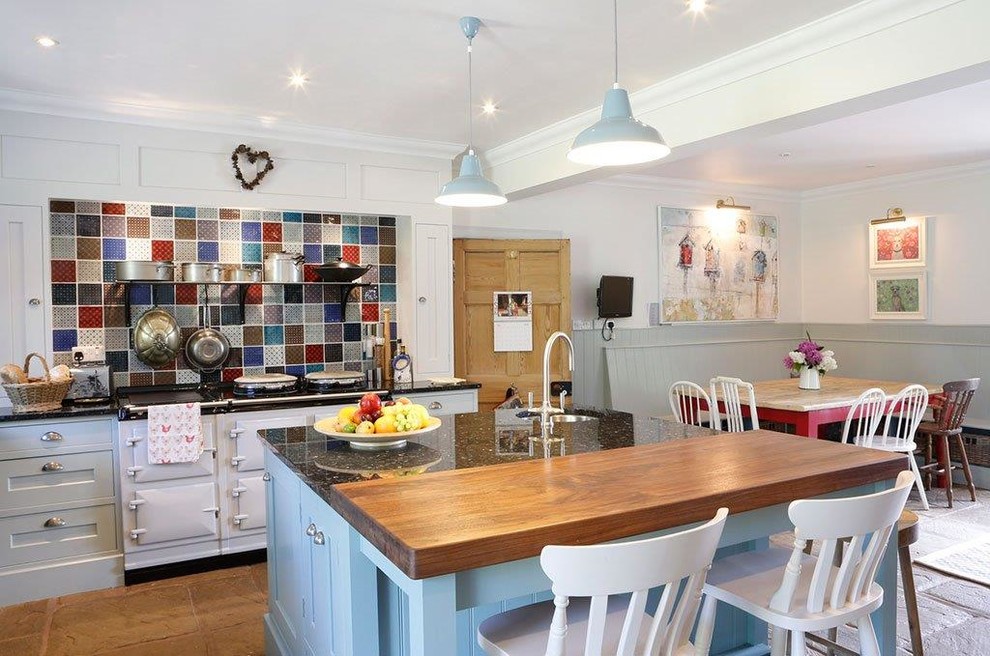 Inspiration for a large country l-shaped kitchen/diner in Other with a submerged sink, recessed-panel cabinets, blue cabinets, granite worktops, multi-coloured splashback, terracotta flooring, a breakfast bar and white appliances.