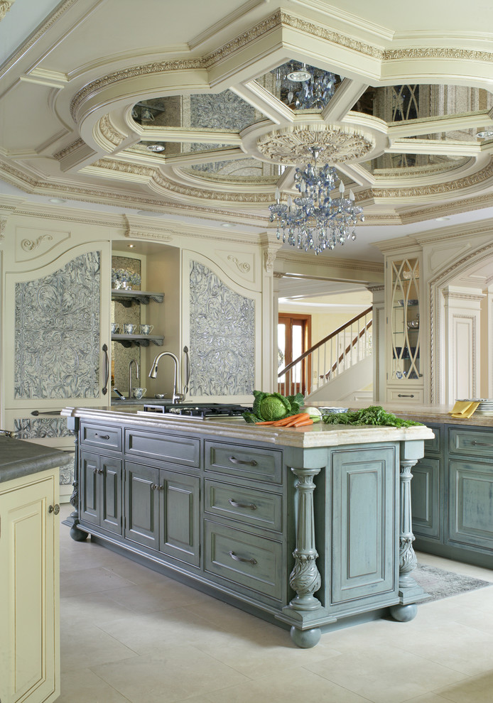 Eat-in kitchen - large traditional u-shaped limestone floor eat-in kitchen idea in New York with a farmhouse sink, beaded inset cabinets, beige cabinets, limestone countertops, beige backsplash, mosaic tile backsplash, black appliances and two islands
