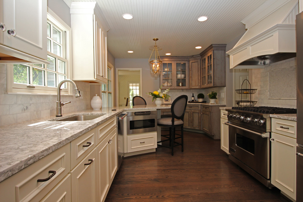 Example of a mid-sized classic u-shaped dark wood floor eat-in kitchen design in Detroit with a single-bowl sink, flat-panel cabinets, white cabinets, quartz countertops, multicolored backsplash, stone tile backsplash, stainless steel appliances and a peninsula