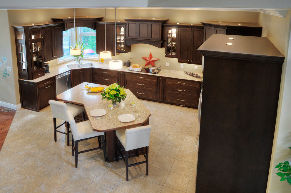 Large traditional u-shaped kitchen/diner in Other with a built-in sink, shaker cabinets, dark wood cabinets, laminate countertops, stainless steel appliances, travertine flooring and an island.