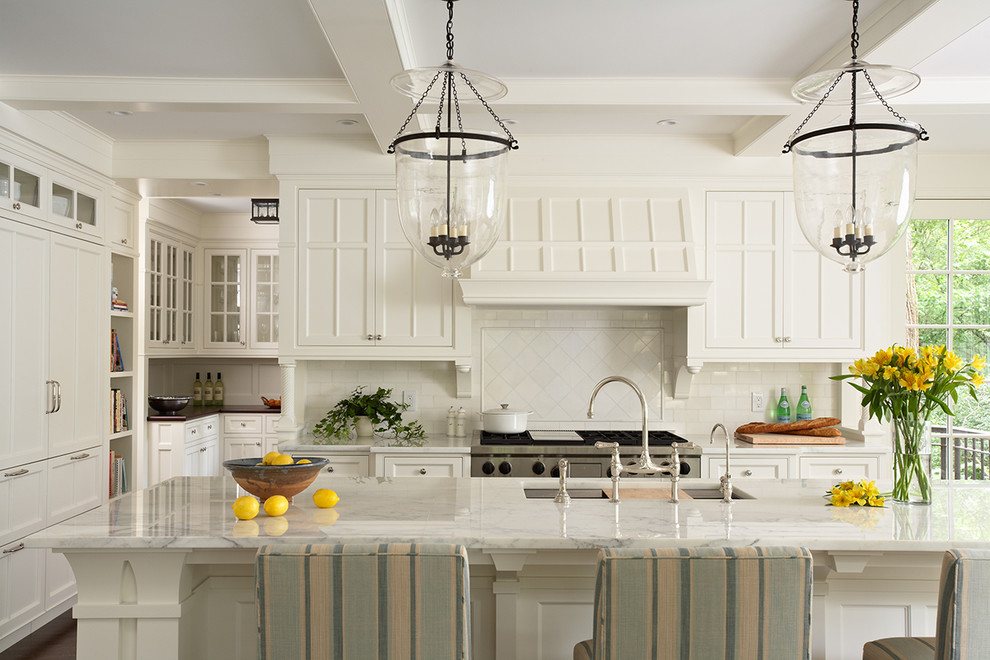 Eat-in kitchen - huge traditional eat-in kitchen idea in Minneapolis with an undermount sink, beaded inset cabinets, white cabinets, marble countertops, white backsplash, subway tile backsplash, stainless steel appliances and an island