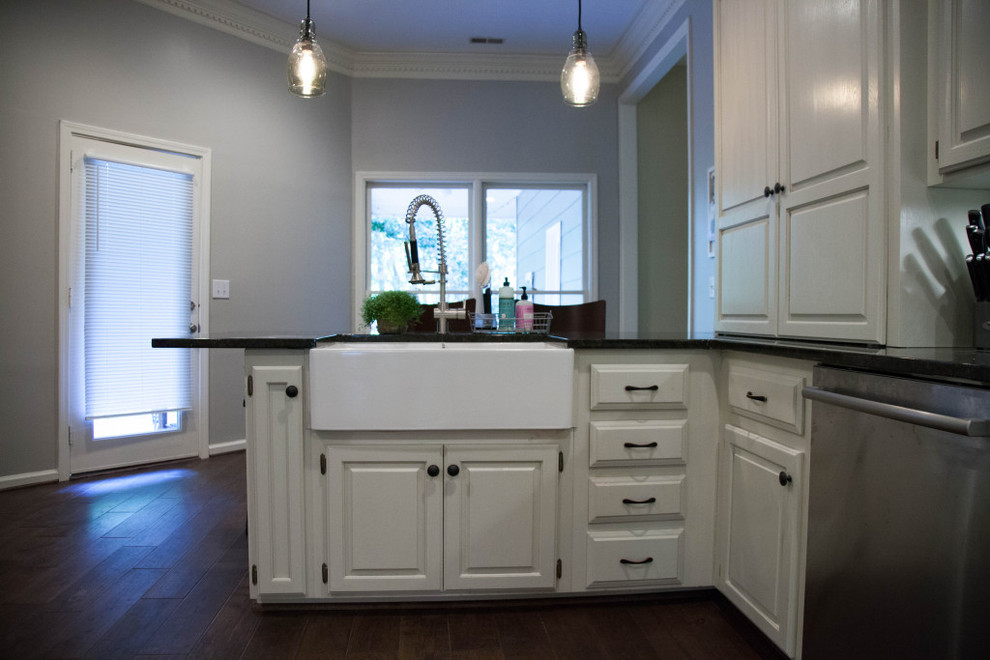 Eat-in kitchen - mid-sized rustic l-shaped dark wood floor eat-in kitchen idea in Birmingham with a farmhouse sink, raised-panel cabinets, white cabinets, granite countertops, white backsplash, subway tile backsplash and stainless steel appliances