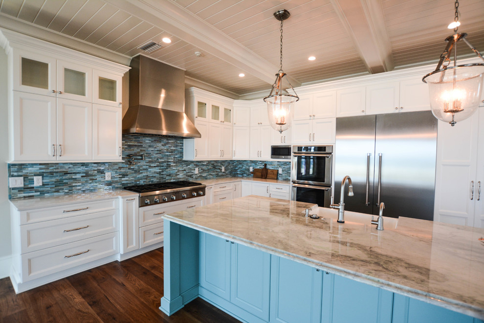 Beach style l-shaped dark wood floor and brown floor open concept kitchen photo in Jacksonville with a farmhouse sink, shaker cabinets, white cabinets, marble countertops, multicolored backsplash, matchstick tile backsplash, stainless steel appliances and an island