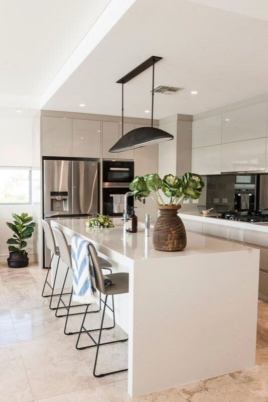 Inspiration for a mid-sized modern l-shaped marble floor and beige floor open concept kitchen remodel with an undermount sink, beige cabinets, quartz countertops, glass sheet backsplash, stainless steel appliances, an island and gray countertops