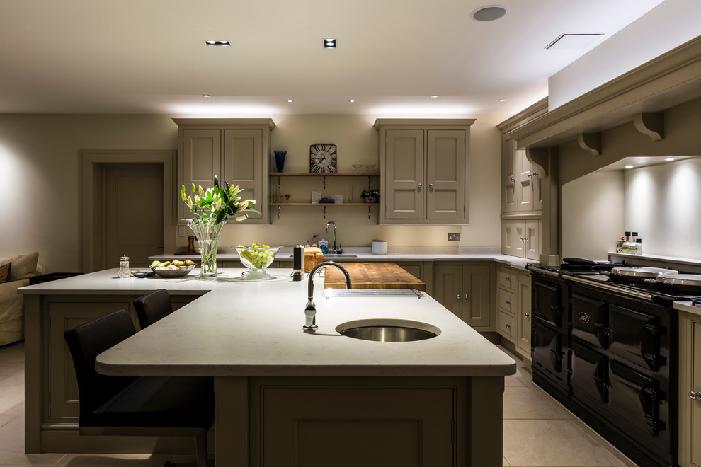 Large traditional l-shaped open plan kitchen in Surrey with a submerged sink, shaker cabinets, green cabinets, marble worktops, black appliances, ceramic flooring and an island.