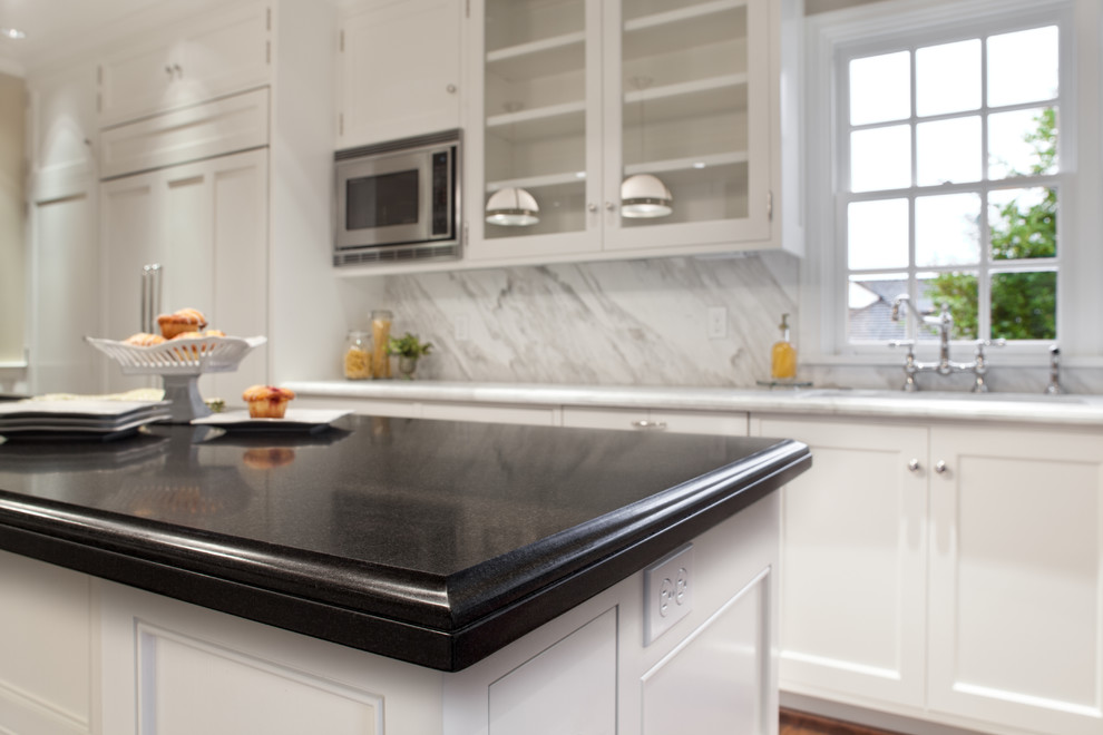 Elegant kitchen photo in Portland with an undermount sink, granite countertops and stone slab backsplash
