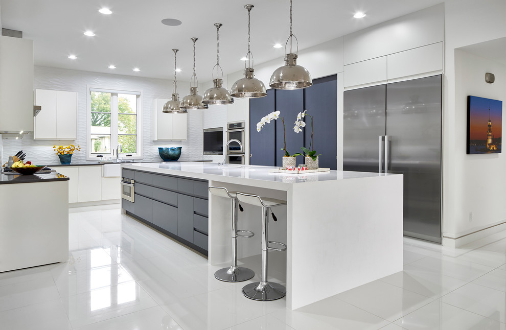 Inspiration for a contemporary u-shaped kitchen in Oklahoma City with flat-panel cabinets, white cabinets, white splashback, stainless steel appliances and an island.