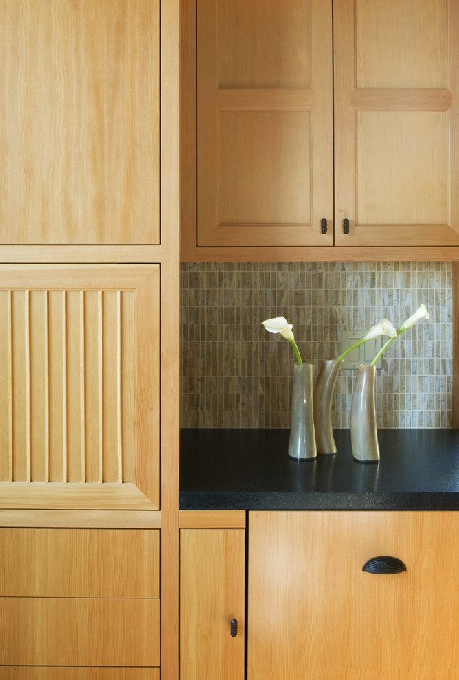 Example of a trendy kitchen design in San Francisco with medium tone wood cabinets and green backsplash