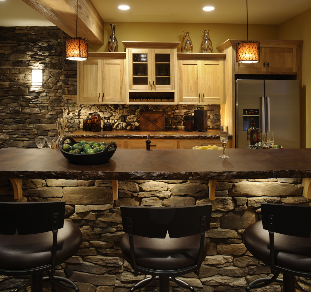 Mountain style galley kitchen photo in Columbus with stainless steel appliances, concrete countertops, shaker cabinets and light wood cabinets